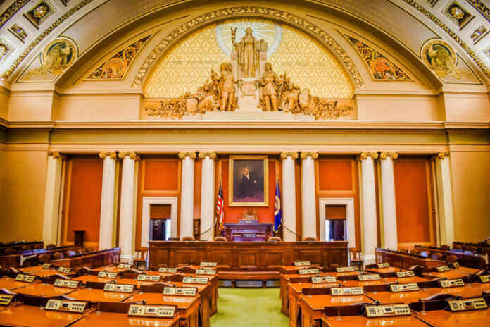 shutterstock1734668444jpg Interior view of a legislative chamber with wooden furniture and decorative ceiling