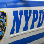 Close-up of a New York Police Department vehicle with badge and NYPD lettering