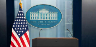 BREAKING: Gunfire Chaos Strikes White House Podium with microphones in front of the White House seal and an American flag