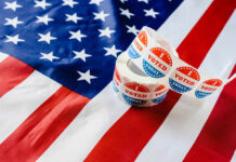 Fraud Claims Unravel: Just Political Theater? Voting stickers on an American flag background