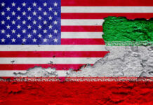 A textured wall featuring the flags of the USA and Iran