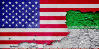A textured wall featuring the flags of the USA and Iran