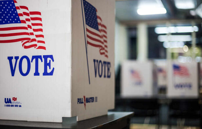 Brownfield,,Tx,-,10/09/2020,-,Voting,Booths,At,Polling,Station Voting booths with American flags in a polling station
