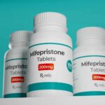 Three bottles of Mifepristone tablets on a shelf