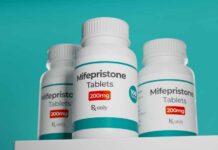 Three bottles of Mifepristone tablets on a shelf