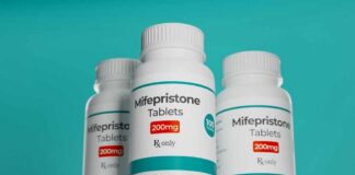 Three bottles of Mifepristone tablets on a shelf