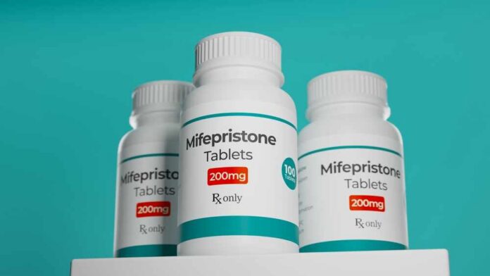 Three bottles of Mifepristone tablets on a shelf