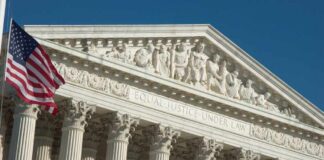 United States Supreme Court facade with flag and Corinthian columns