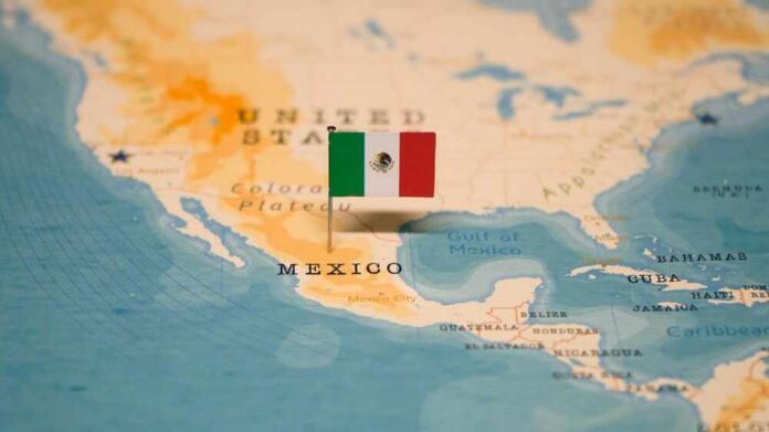 Map of North America with a flag of Mexico pinned on it