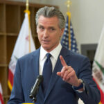 A government official speaking at a podium during a press conference