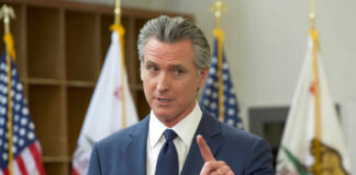 New Law SHIFTS Election Power in California A government official speaking at a podium during a press conference