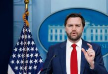 White House Unveils $1.34 Billion Spending Freeze Government official speaking at a press conference in front of the White House