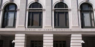 STUNNING 115,000 Jobs Added — Expectations Crushed! Facade of the Bureau of Labor Statistics building with a person walking by