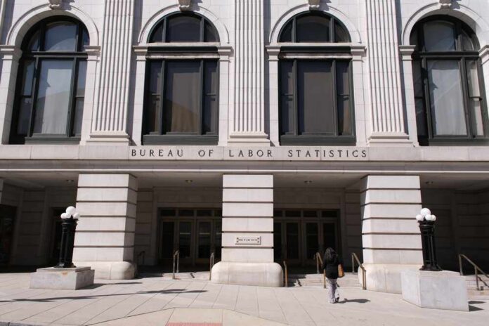 Facade of the Bureau of Labor Statistics building with a person walking by