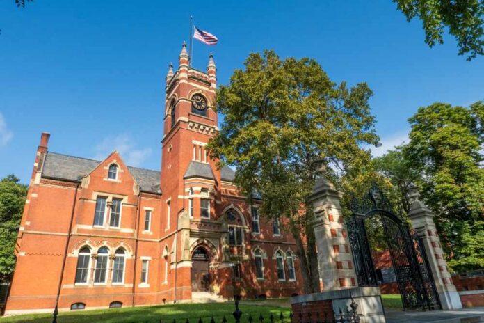 Historic red brick building with a clock tower and American flag