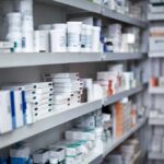 TrumpRx: The Drug Price Fix Dems Refused to Build Shelves filled with various medication boxes and containers in a pharmacy