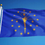 GOP In Turmoil: Trump-Backed Candidates Dominate Indiana state flag waving against a blue sky