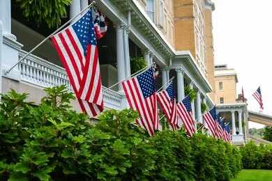 American flags hanging along a historic building porch