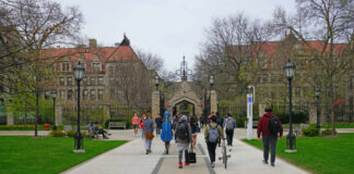 Dorm Predator Still Loose — Parents Revolt Students walking along a pathway on a university campus with historic buildings in the background