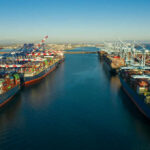 The Red Sea Crisis Just Escalated Aerial view of cargo ships docked at a shipping port