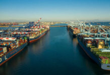 The Red Sea Crisis Just Escalated Aerial view of cargo ships docked at a shipping port