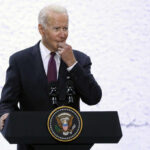 Biden Returns Swinging At Trump A man in a suit speaking at a podium with a presidential seal