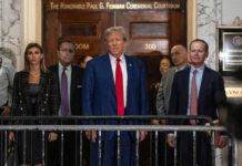Judge Slaps Brakes On White House Rebuild A group of individuals, including a political figure, standing in front of a courtroom entrance