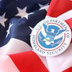 Federal Squeeze Sparks Election War U.S. Department of Homeland Security emblem on an American flag