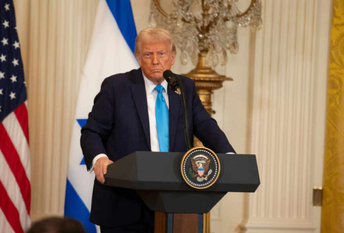 shutterstock2581782645jpg A political figure speaking at a podium with American and Israeli flags in the background