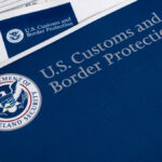 Court Fight Over Endless ICE Detention U.S. Customs and Border Protection documents on a table