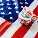 Four Republicans Torch Voter ID Push Voting stickers on an American flag background