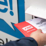 New Illegal Voting Cases Draw Attention Person placing a mail-in ballot into a voting drop box