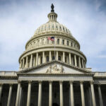 War Powers Revolt—Republican Defies Trump The U.S. Capitol building with an American flag flying in front