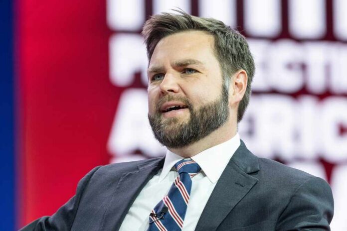 Us,Senator,J.,D.,Vance,Speaks,On,The,1st,Day A man in a suit speaking at a conference with a colorful background