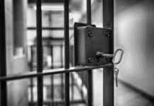 Outrage Erupts: Child Murder, Release Still Possible Close-up of a jail cell lock with a key hanging