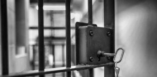Outrage Erupts: Child Murder, Release Still Possible Close-up of a jail cell lock with a key hanging