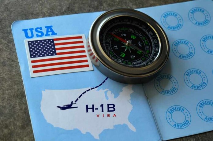 H1-b,Visa,Concept,With,Us,Flag,And,Compass,Placed,Over A compass placed on a travel document featuring an H-1B visa and a map of the USA