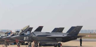 Empty-Nose F-35s Stir Readiness Fears F-35 military jets parked on an airfield with crew members nearby