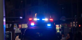 Teen Killed, Case Stalls—What’s Missing? Emergency vehicle with flashing lights in a busy urban area at night