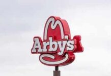 Arby’s Shock: Manager Caught on Camera? Arby's restaurant sign with cowboy hat logo on a pole