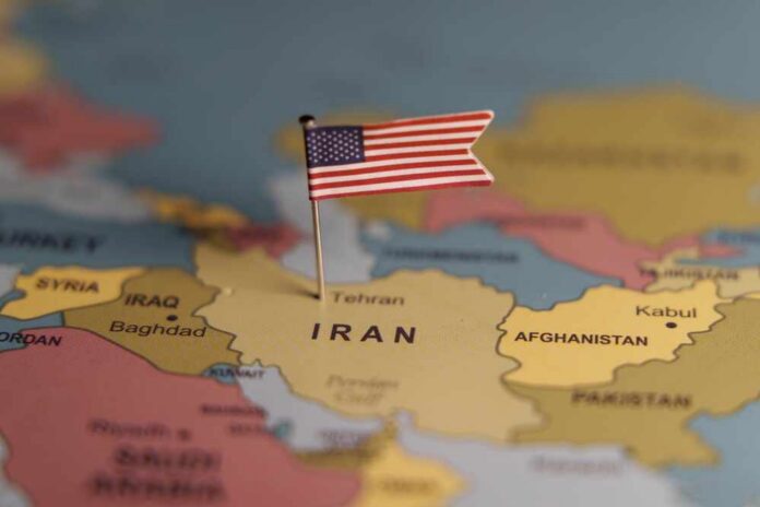 Usa,Flag,Pinned,On,Iran,Map,Symbolizing,Political,Influence,,Conflict, A map highlighting Iran with a small American flag pin