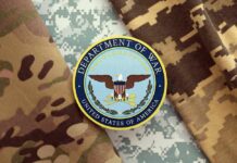 Quiet Rewrite Sparks Military Faith Uproar Department of War emblem on camouflage fabric