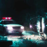 Father Dead, Questions Explode Nationwide A police car with flashing lights at the scene of a flipped vehicle accident
