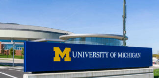 University of Michigan campus sign in front of modern buildings