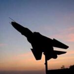 Russian Strike Hits Sumy Civilians Silhouette of a fighter jet mounted on a pedestal at sunset