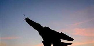 Russian Strike Hits Sumy Civilians Silhouette of a fighter jet mounted on a pedestal at sunset