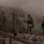 Deadly Orphanage Fire Raises Safety Questions Firefighters spray water into a smoke-filled structure