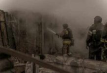 Deadly Orphanage Fire Raises Safety Questions Firefighters spray water into a smoke-filled structure