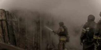 Deadly Orphanage Fire Raises Safety Questions Firefighters spray water into a smoke-filled structure
