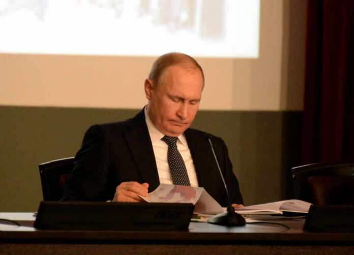 Moscow,,Russia,-,February,28,,2018:,Russian,President,Vladimir,Putin. A leader in formal attire reading documents during a meeting
